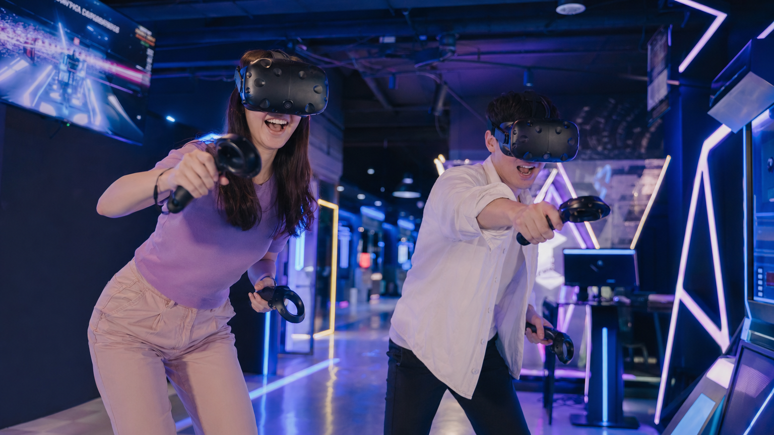 Two people enjoying VR gaming together at an arcade
